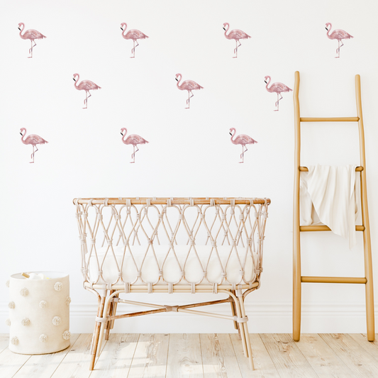 A room with light coloured walls decorated with pink flamingo wall decals, featuring a wooden ladder and a wicker crib in the foreground. Non-toxic, eco-friendly, reusable fabric wall stickers. Australian made.