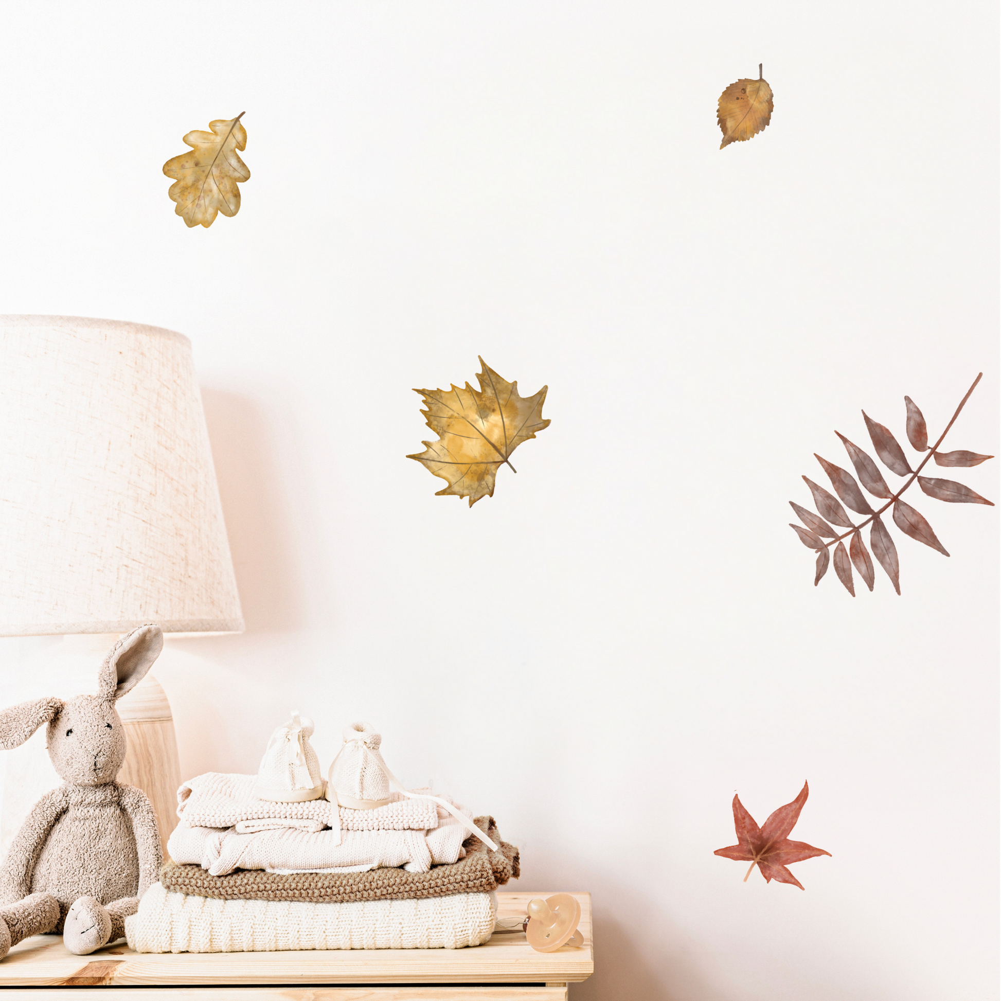 Decorative wall stickers of leaves and a lamp on a white wall. Non-toxic, eco-friendly, reusable wall stickers. Australian made.